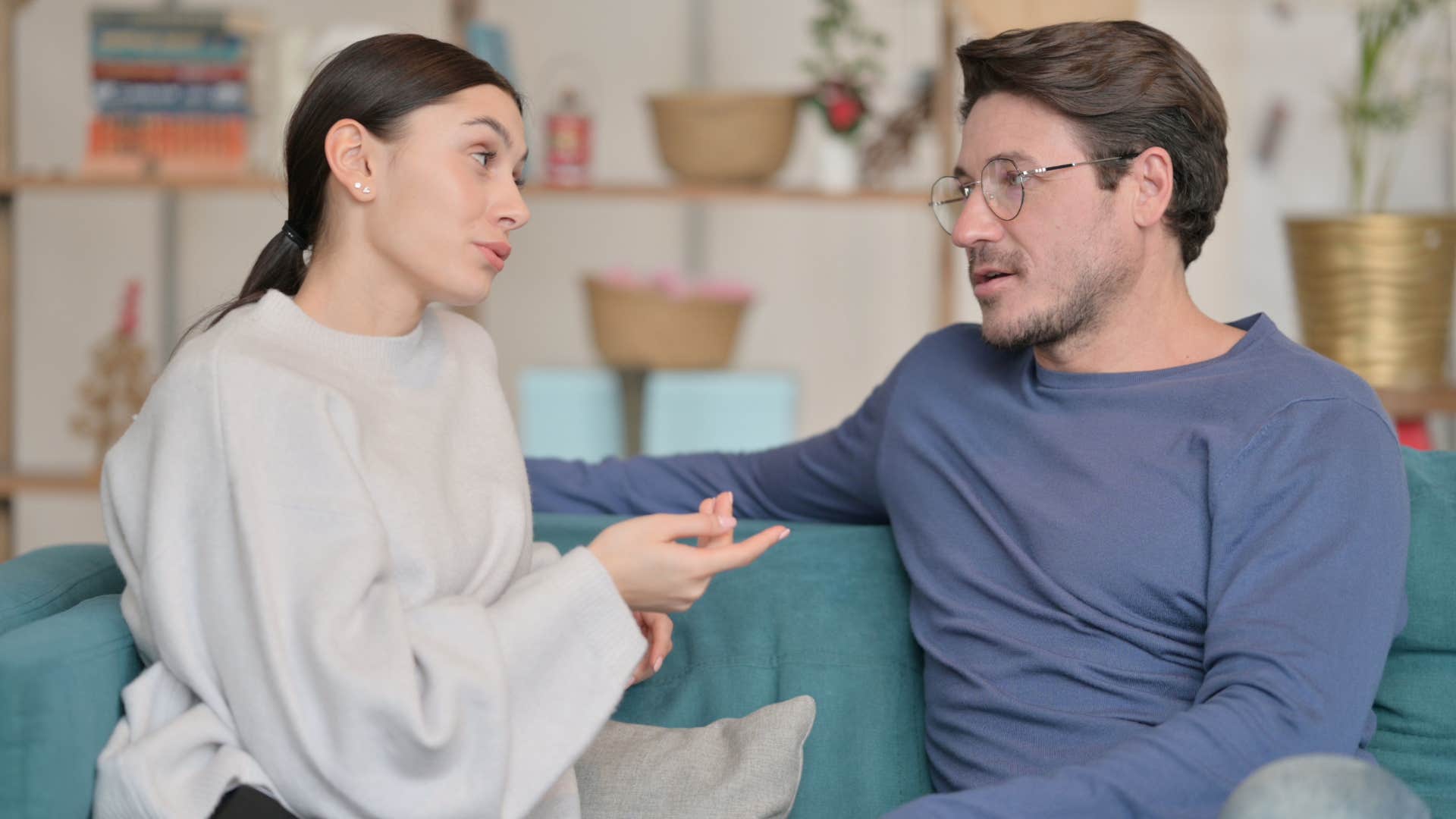 Couple having a conversation on their couch.