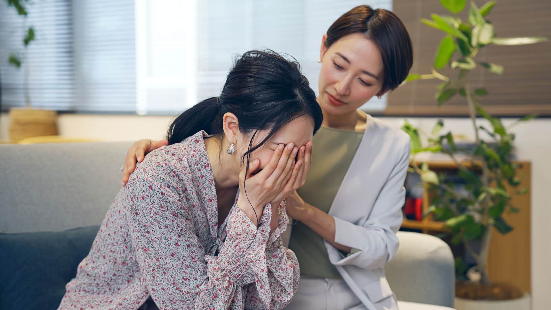 Woman comforting her upset daughter.