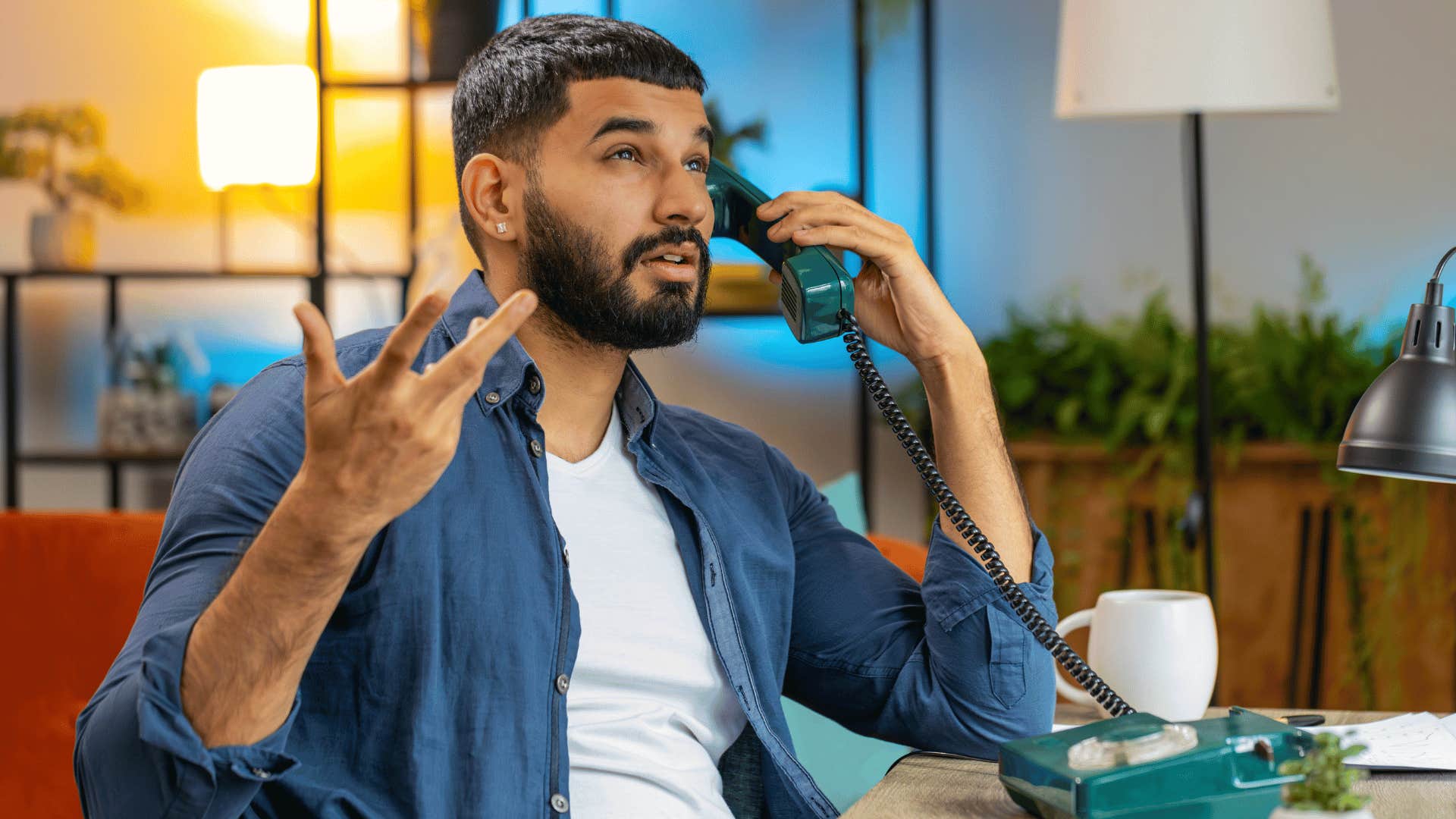 Man using landline phone to make plans for a date