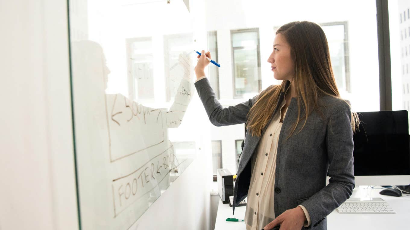 Woman writing on board