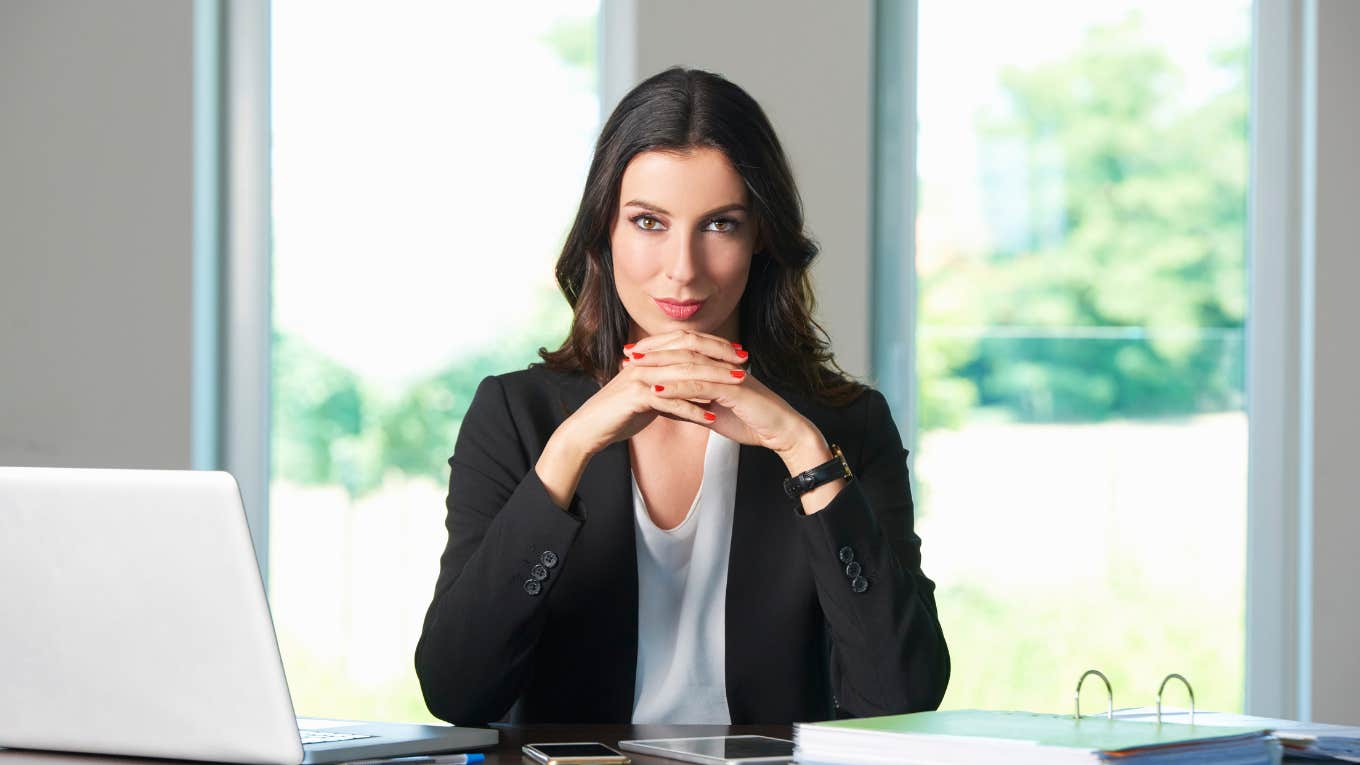 CEO resting chin on hands while sitting at desk