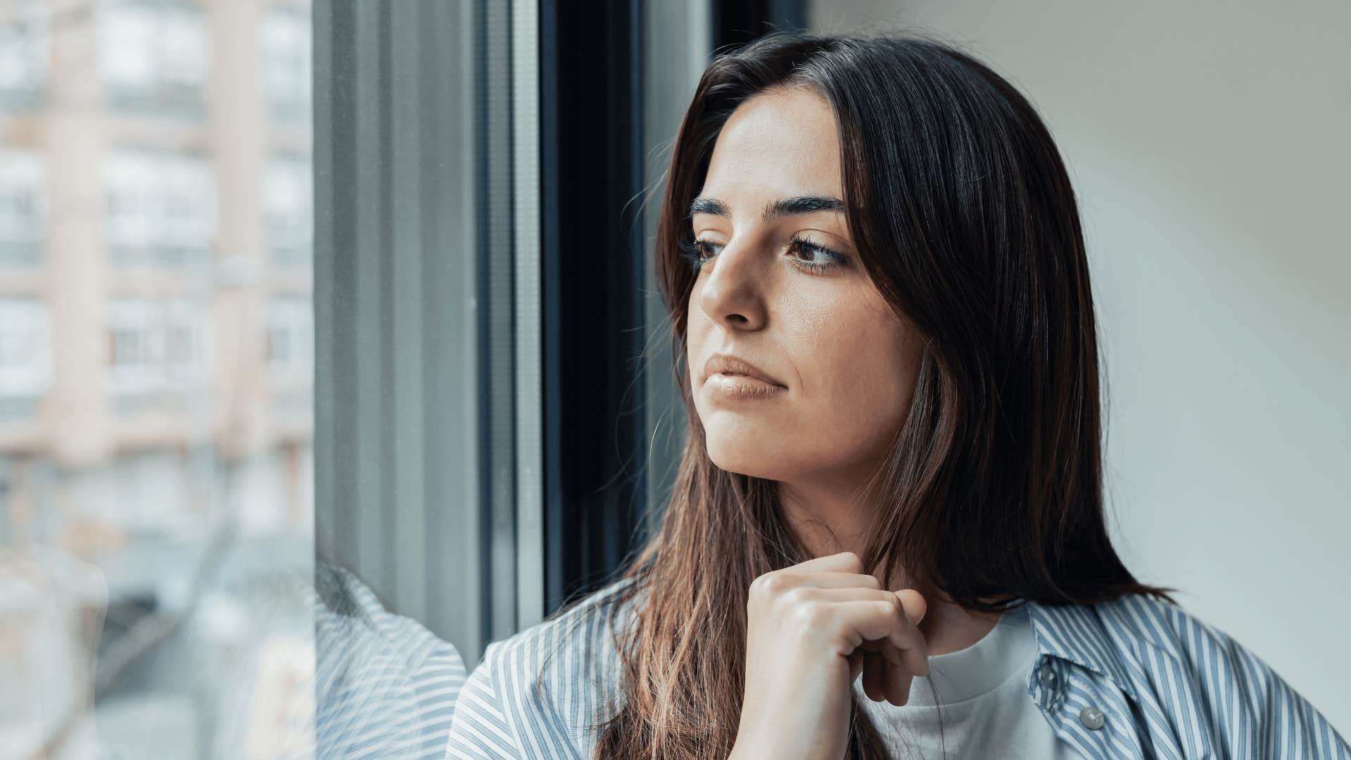 smart woman looking out window