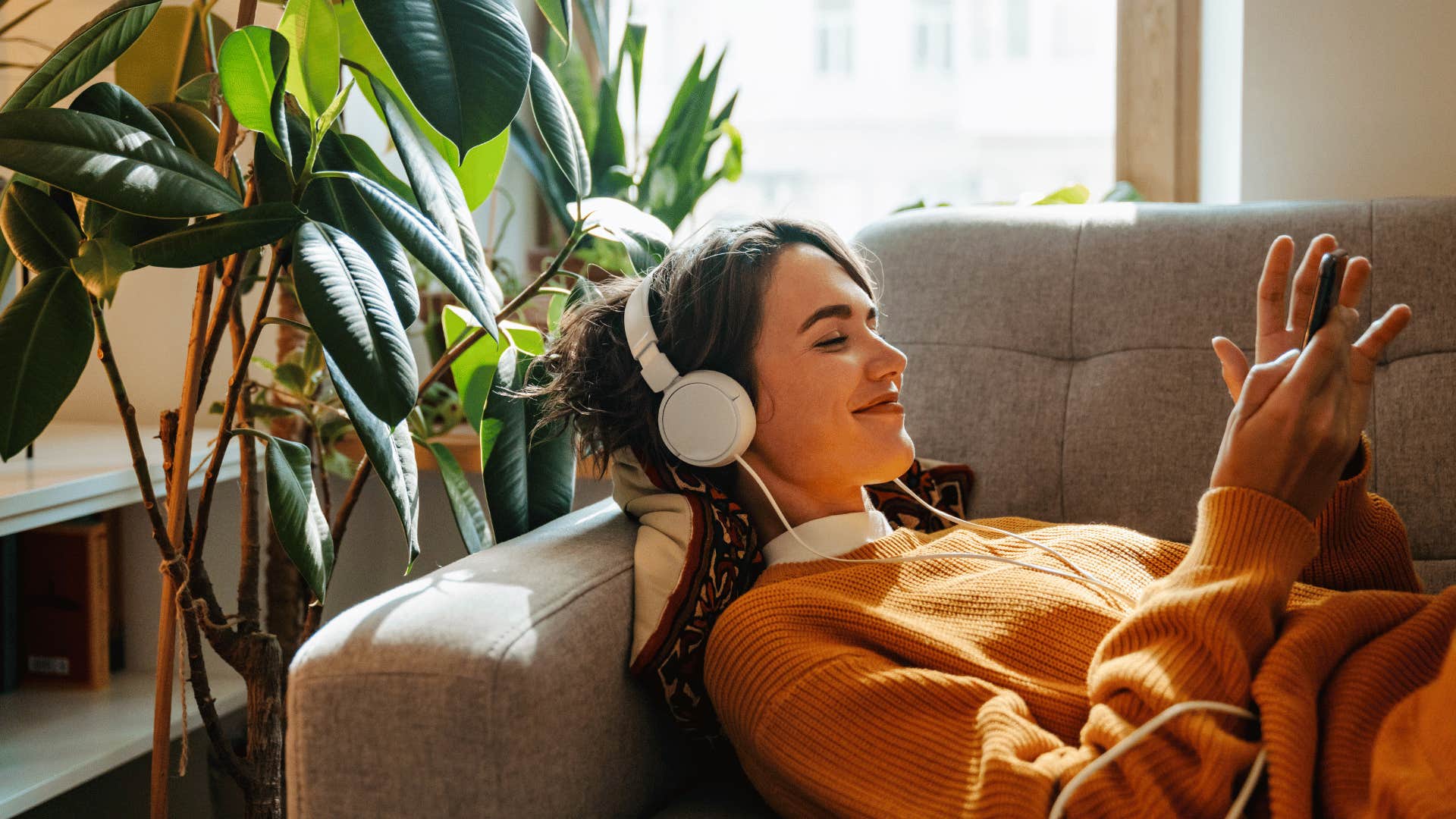 intelligent woman listening to white noise on headphones