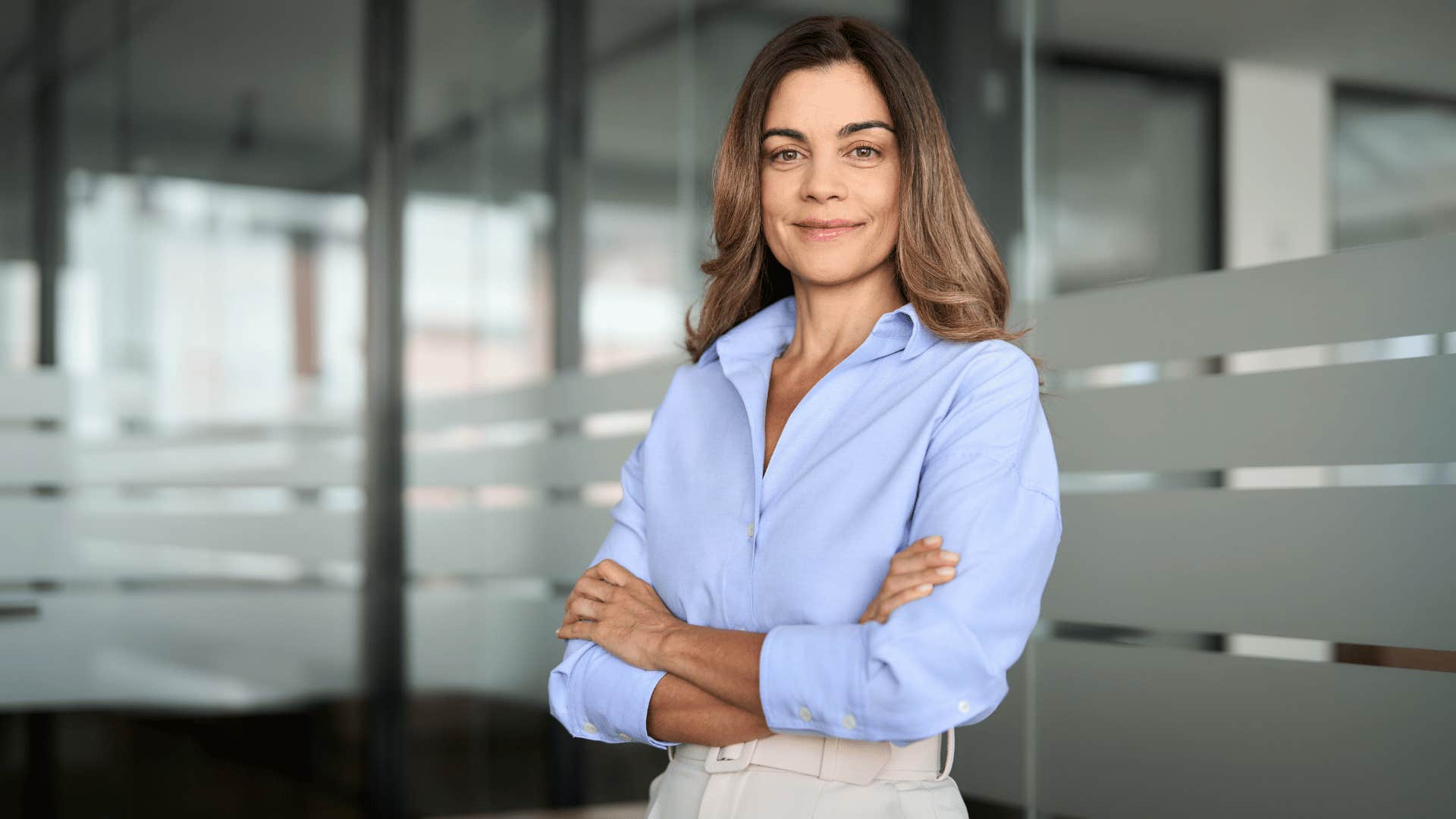 woman crossing arms while smiling