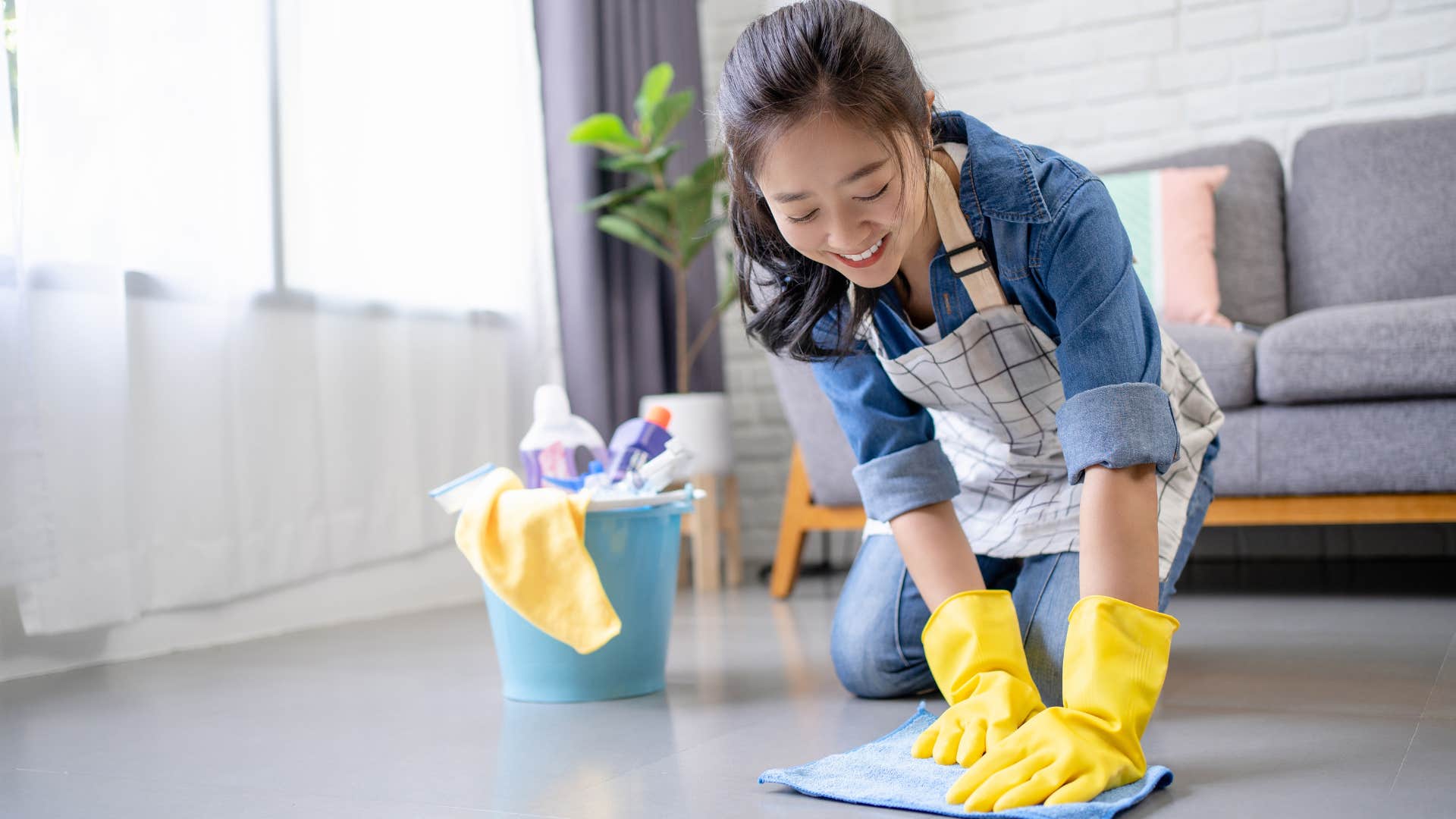 Woman smiling and scrubbing the floors