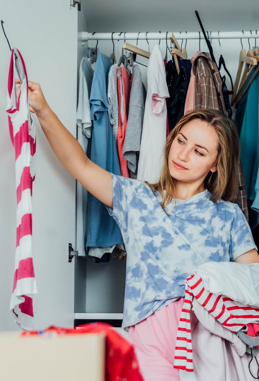 Woman cleaning out her closet