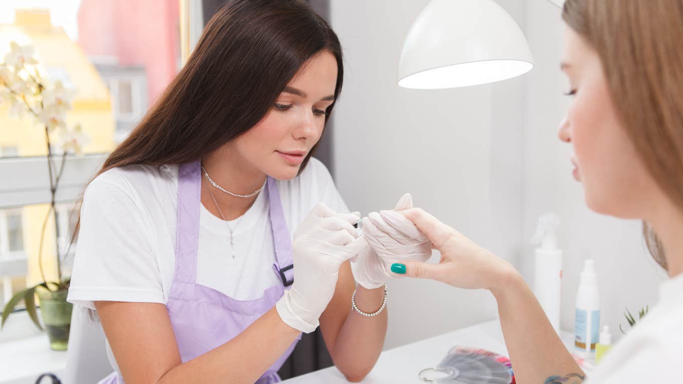 female nail technician doing female client's nails