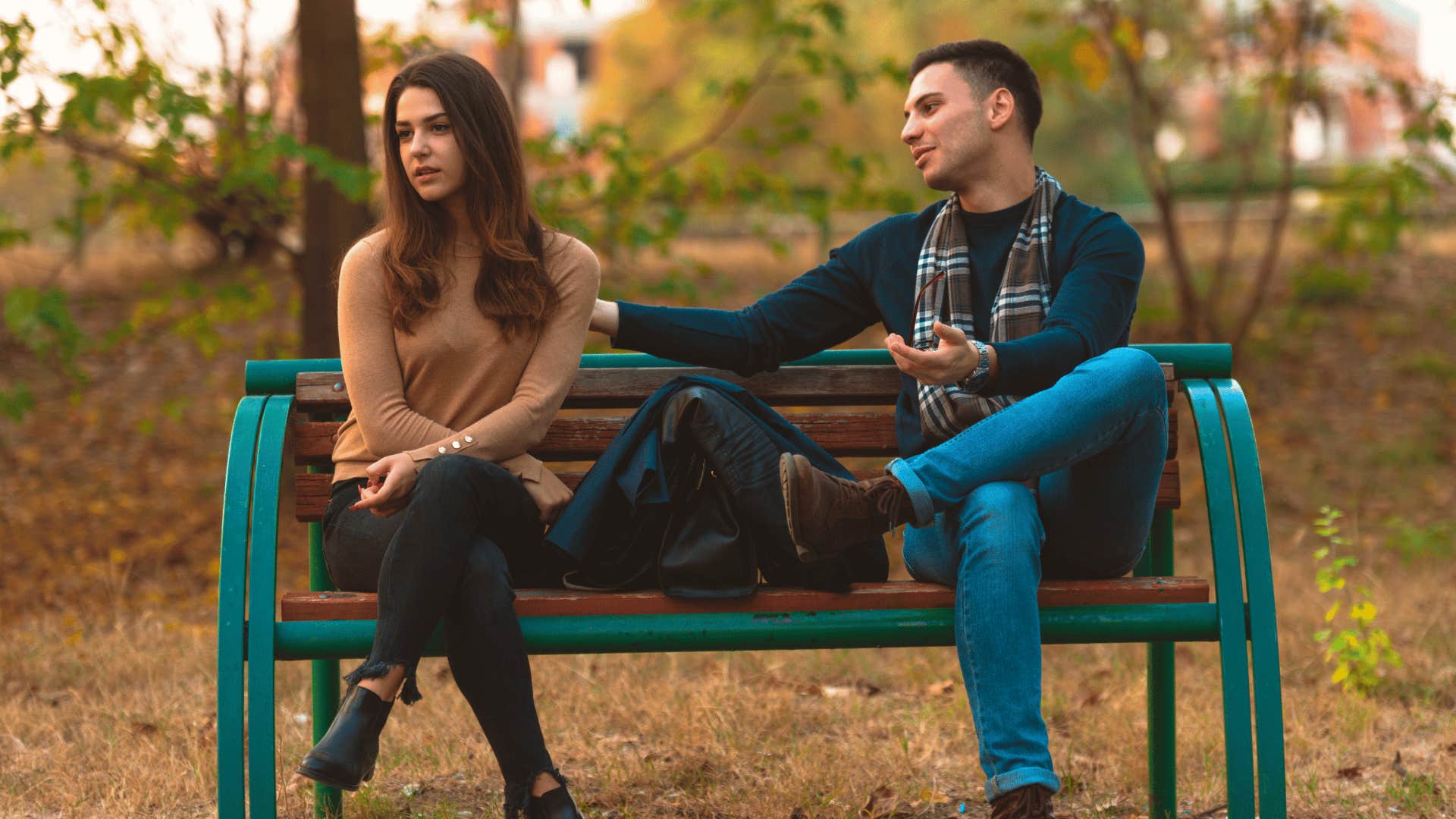 woman ignoring man on bench