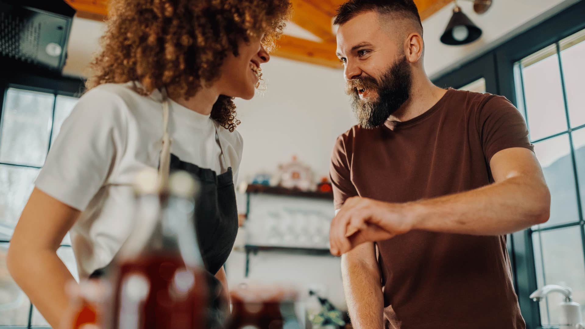 woman and man looking at each other in kitchen