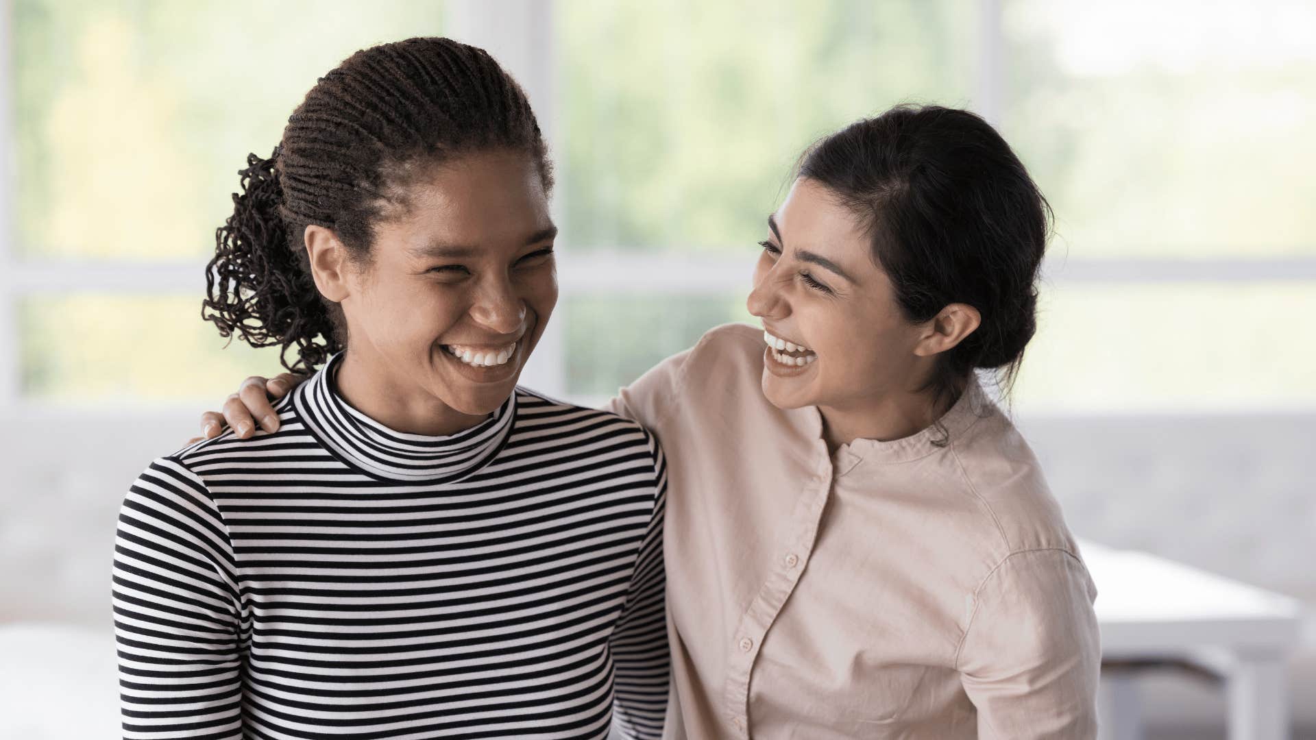 friends smiling and holding each other