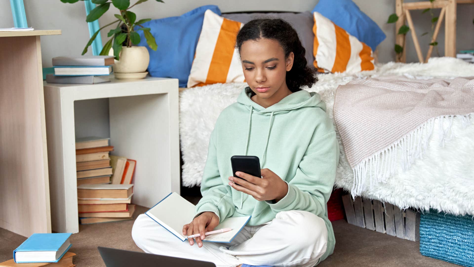 teen girl on her phone and laptop