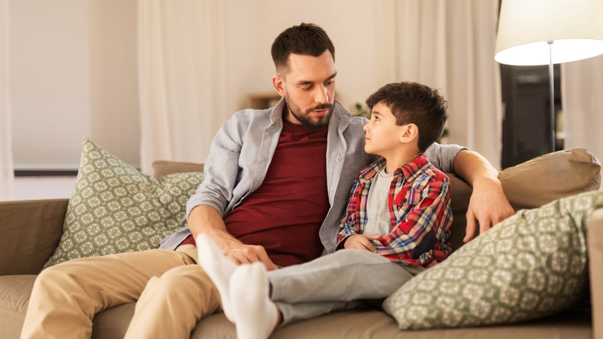 boy having a touch time focusing on talk with father