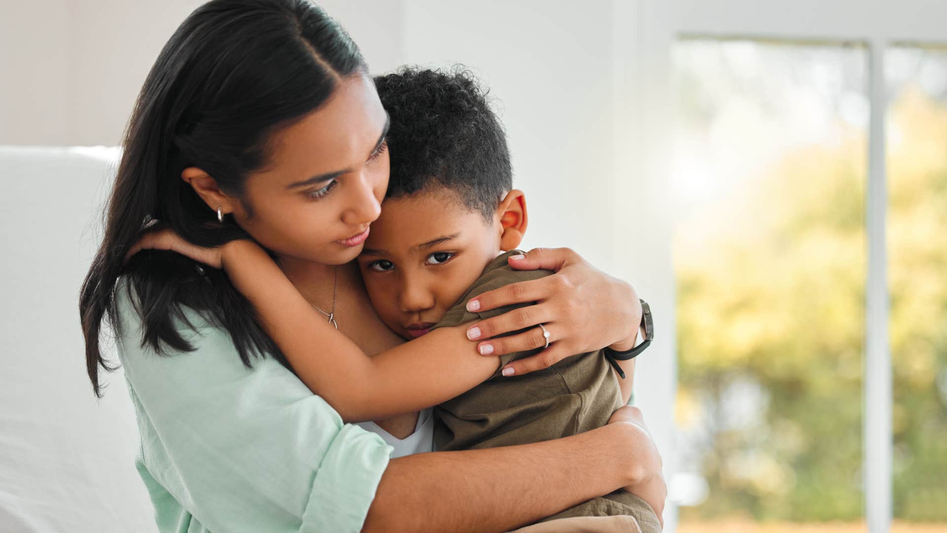 mother hugging upset son