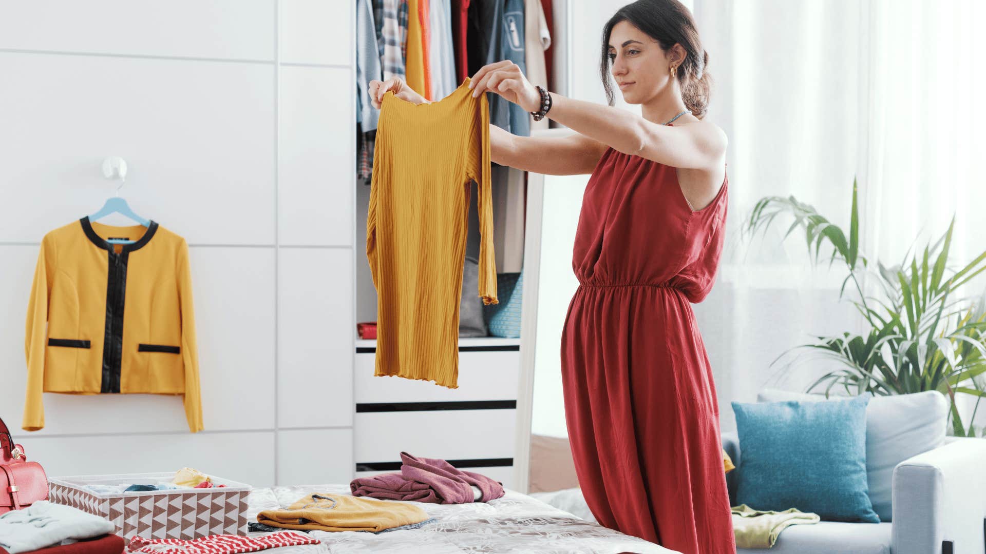 woman holding up shirt