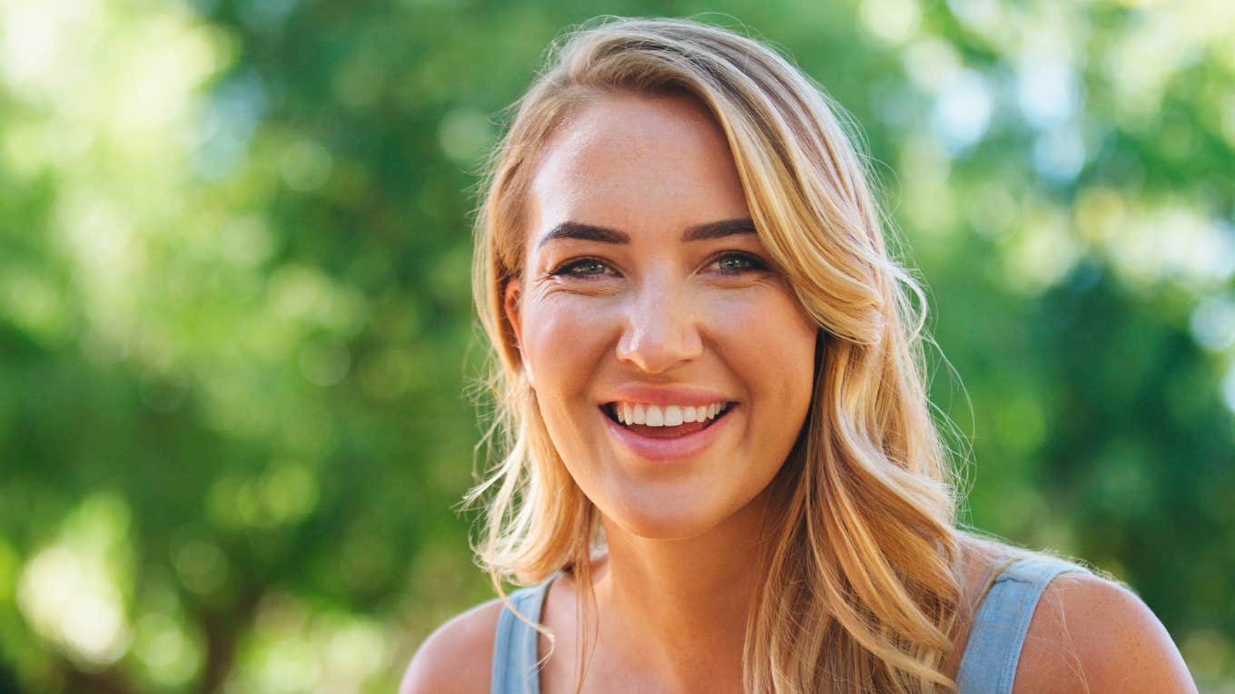 Smiling happy woman outside in the sunshine