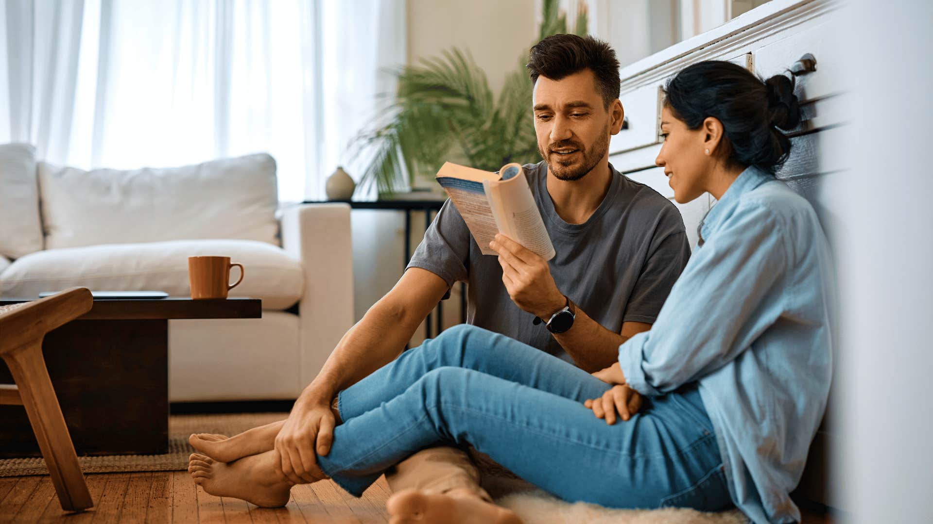 man reading book to woman