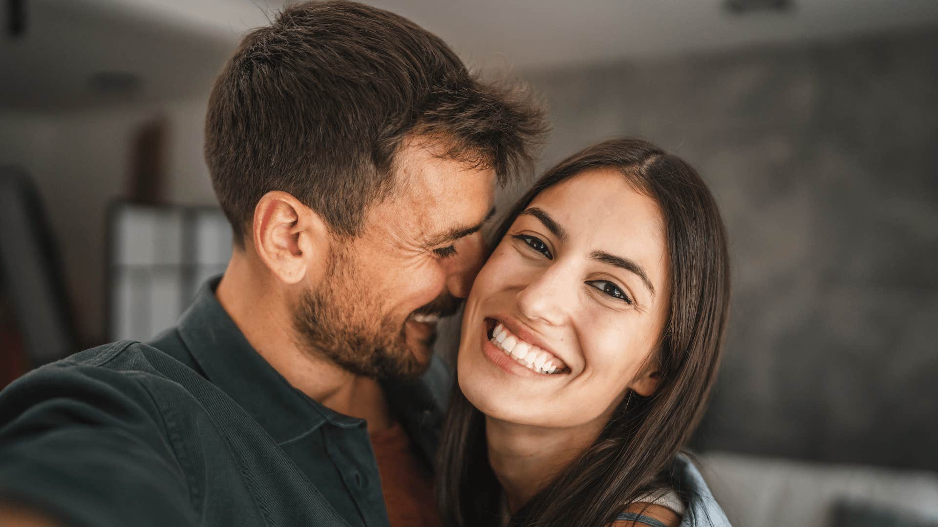 man hugging smiling woman