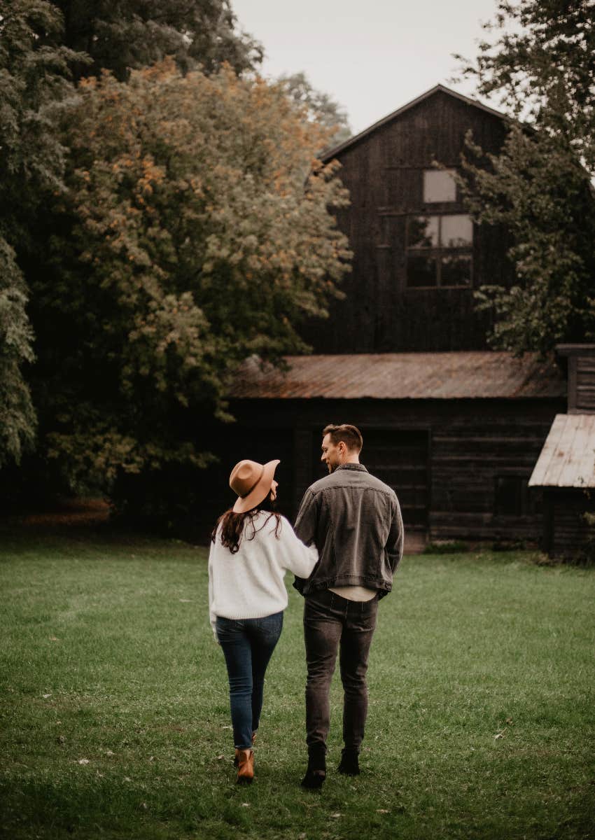 couple walking together towards a house