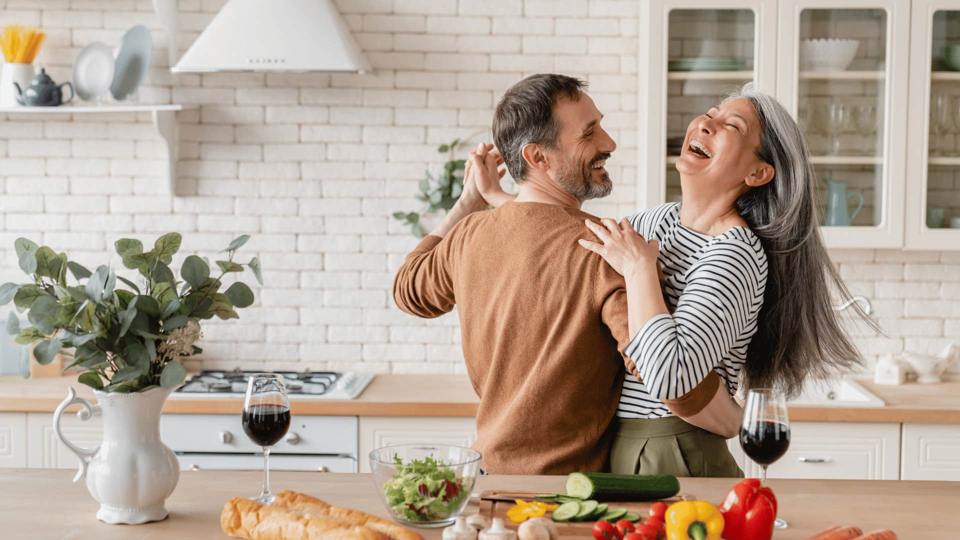 happy couple dancing in kitchen