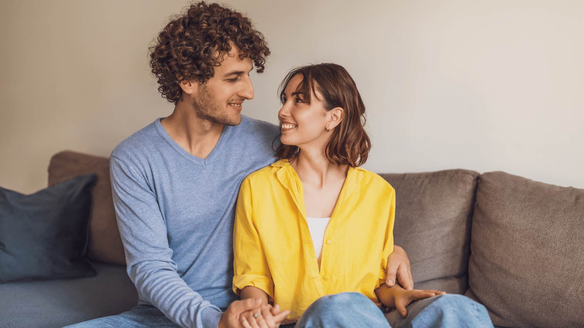 happy couple sitting on couch