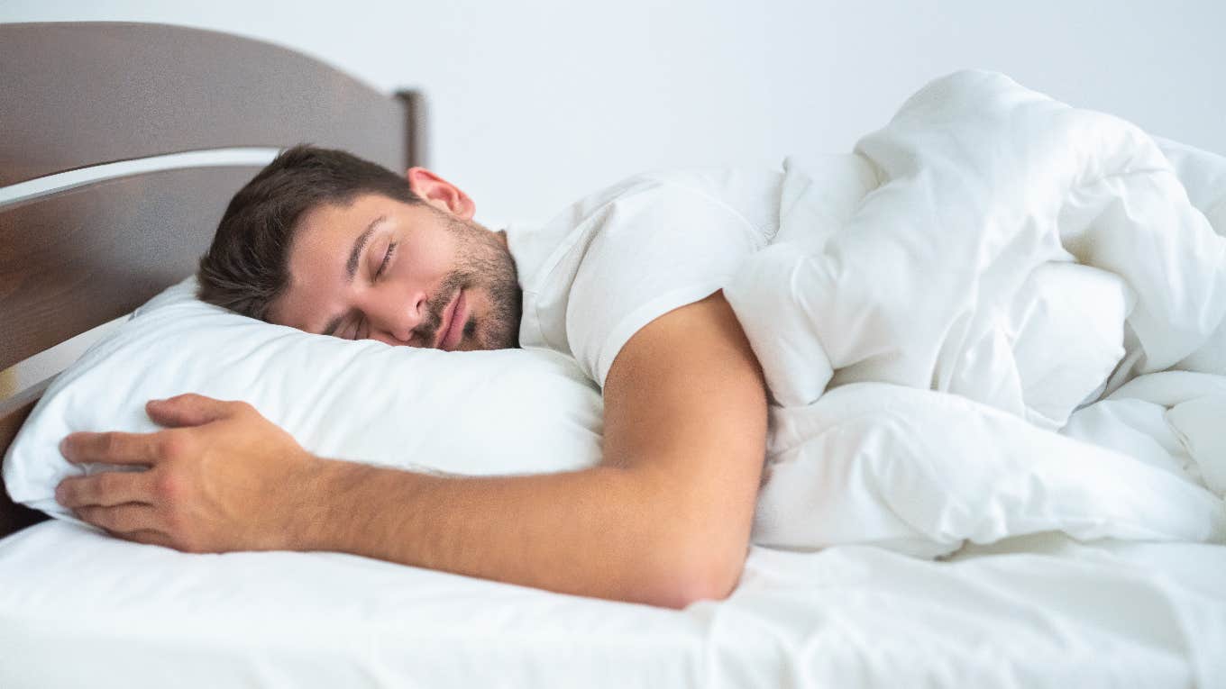 Man sleeping in his bed at home