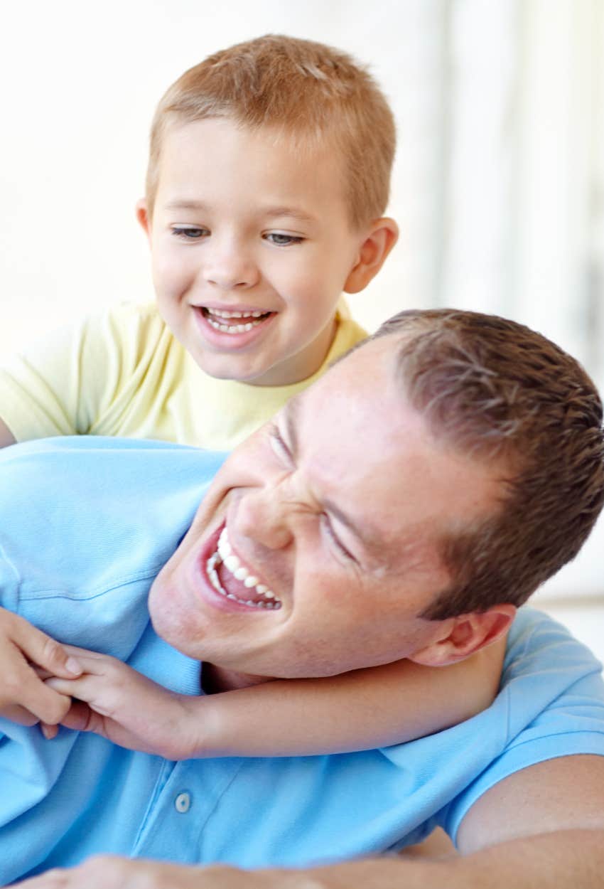 Happy father and son wrestling