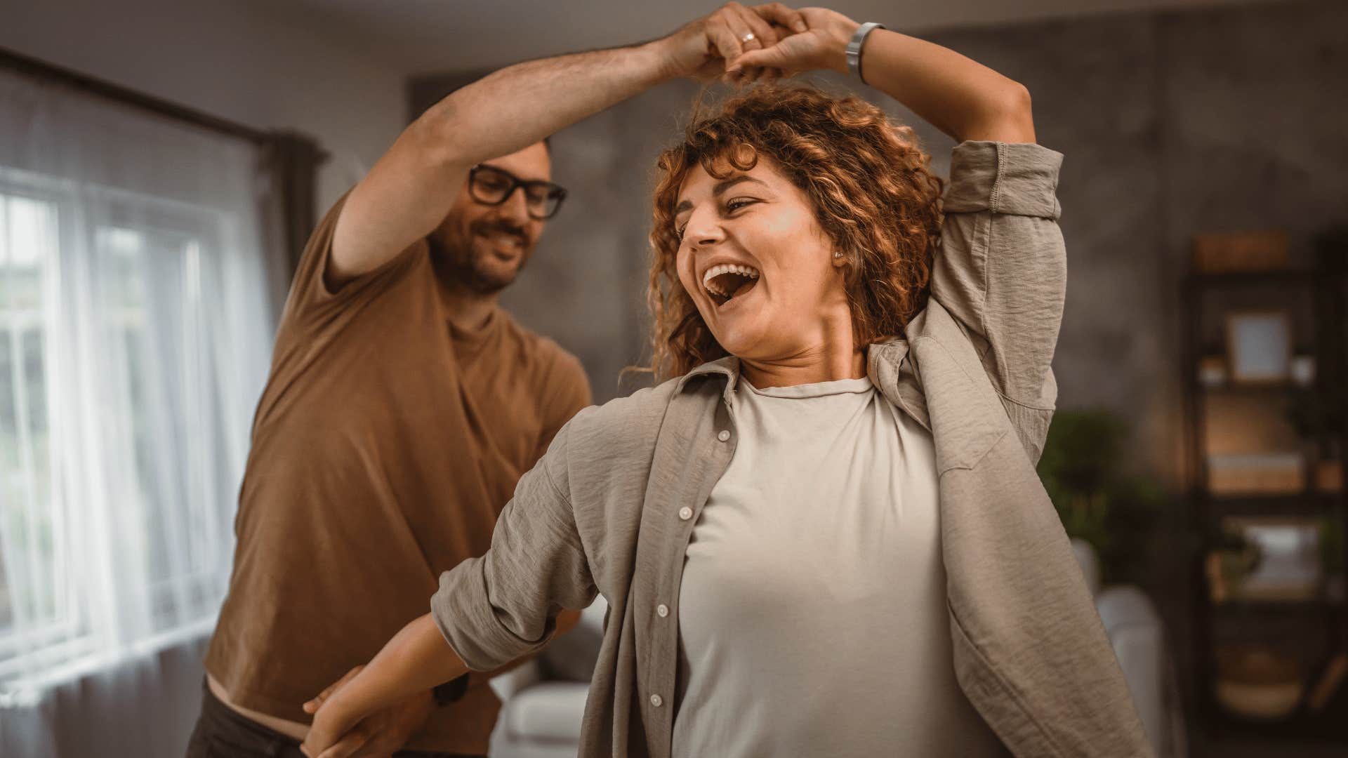 man and woman dancing having fun