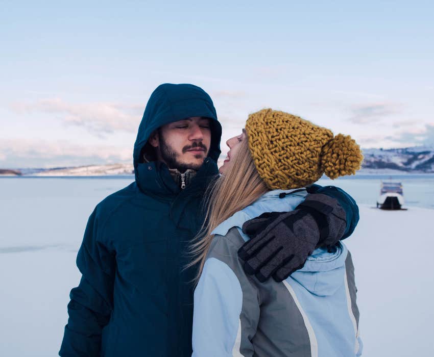 Bearded man and blonde woman hugging after one year together