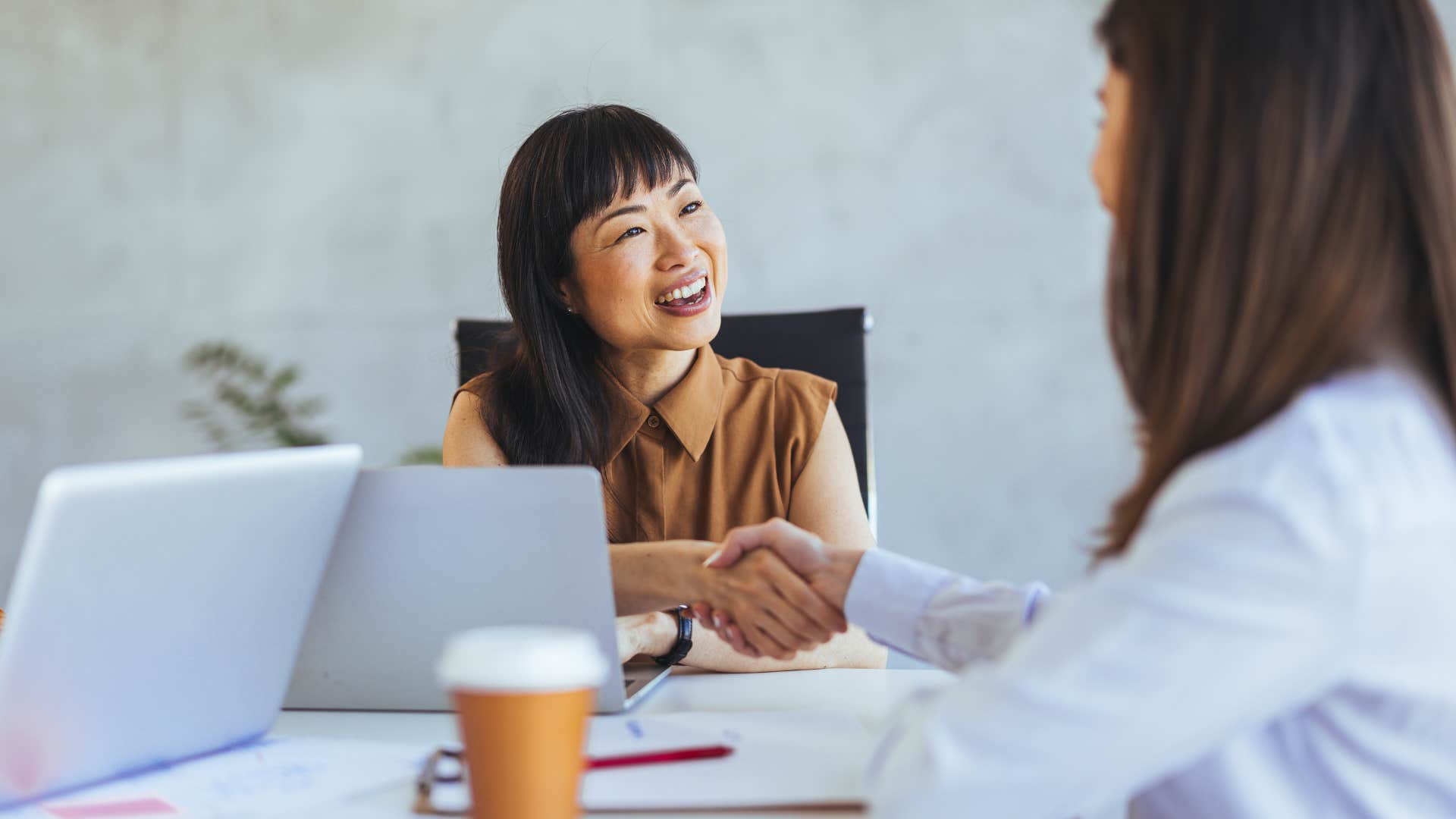 woman shaking hand with new acquaintance