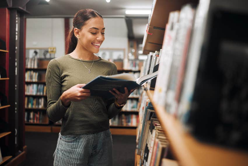 woman reading book in bookstore