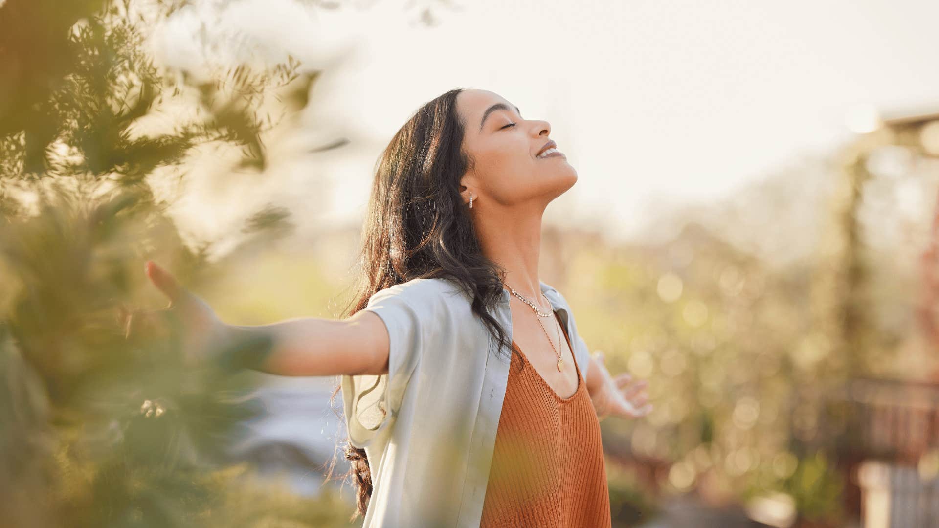 woman smiling with her arms out