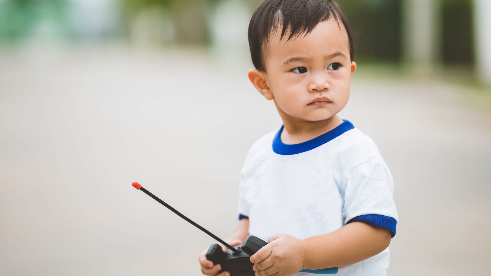 Toddler playing with remote control car