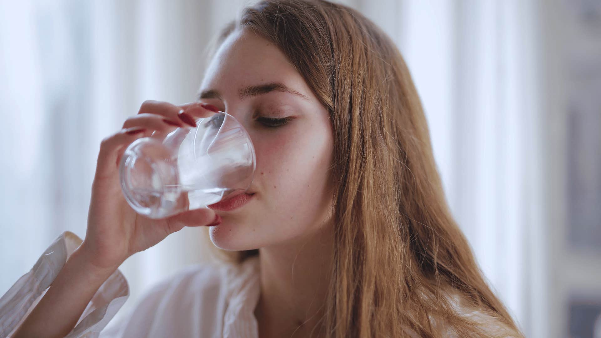 woman drinking a glass of water