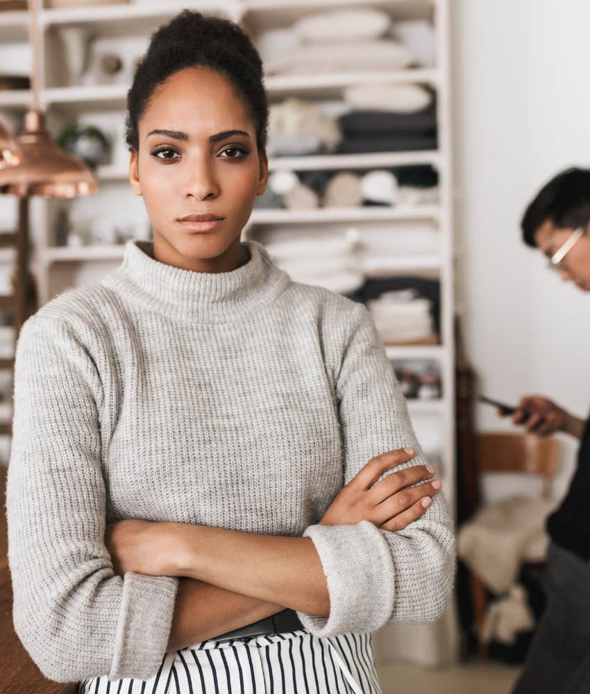 Emotionally strong woman stands in kitchen with zero patience for man's red flags