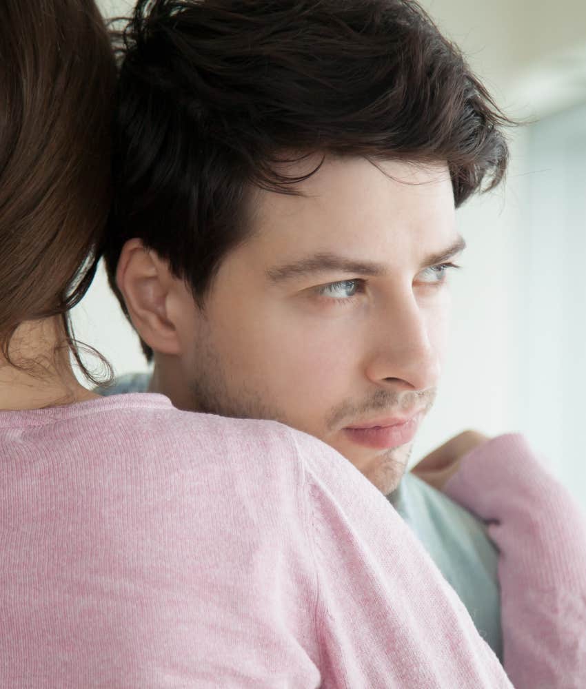 Passive man hugged by emotionally strong woman 