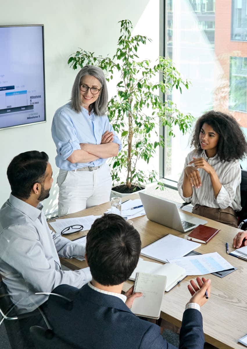 employees in a meeting discussing bereavement leave documentation