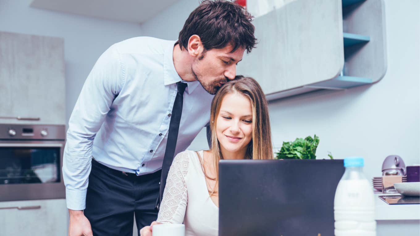 man kissing wife on head before leaving for work