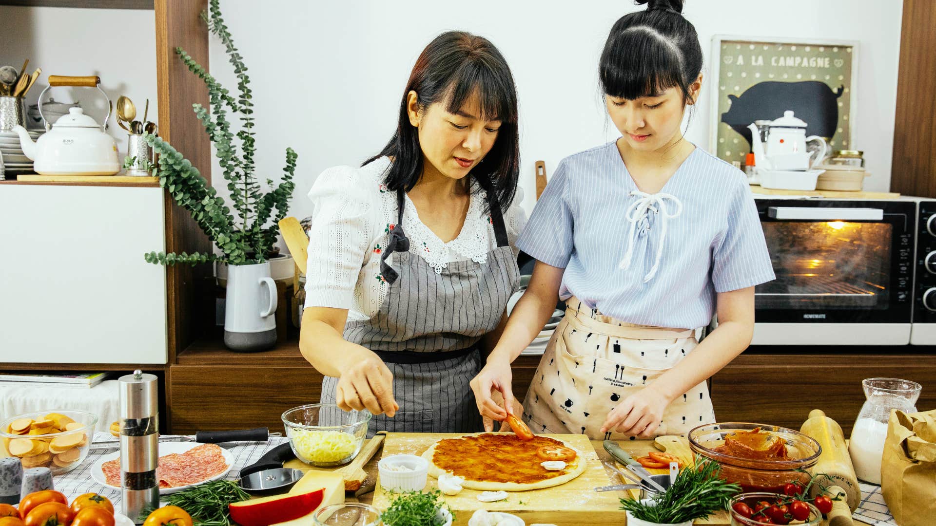 mom teaching daughter cooking basics