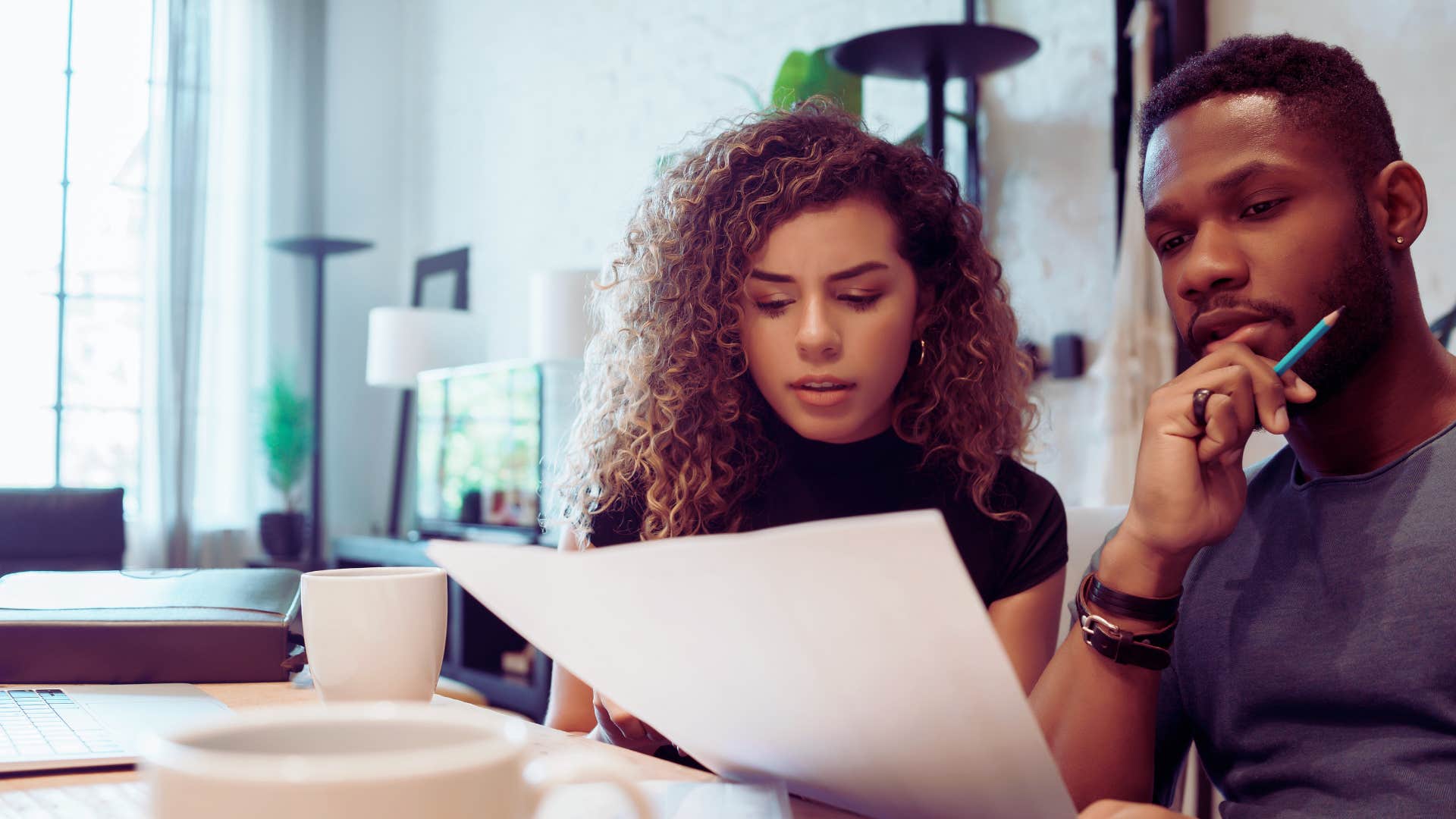 man and woman working on budgeting