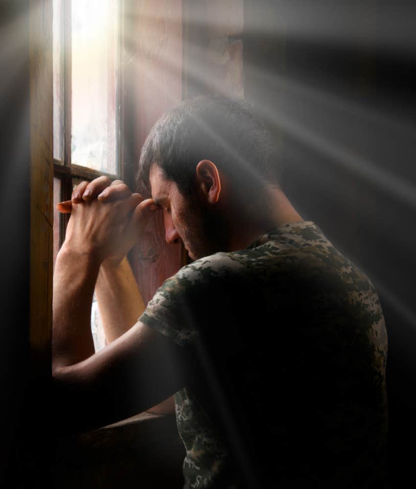 man praying in the window