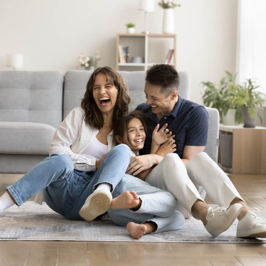 Parents and child laughing together