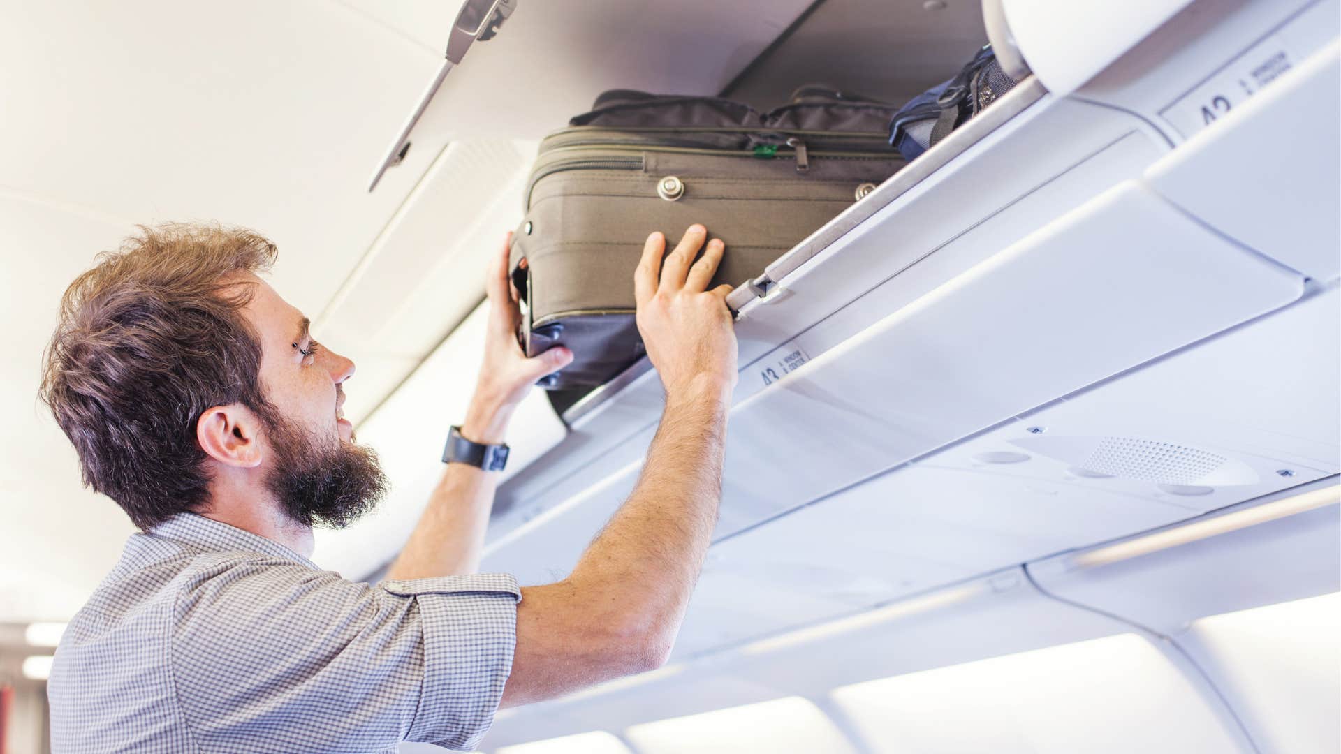 Man, luggage, putting away, compartment