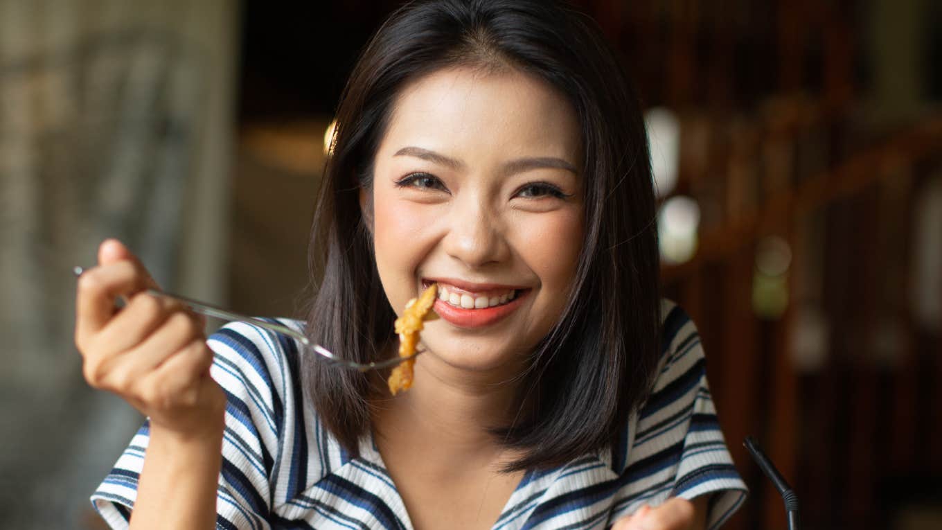 Woman eats food to make her happy.