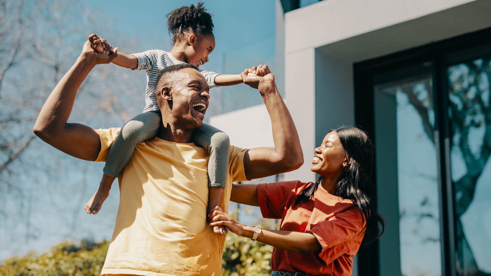 Family playing outside behind their house.