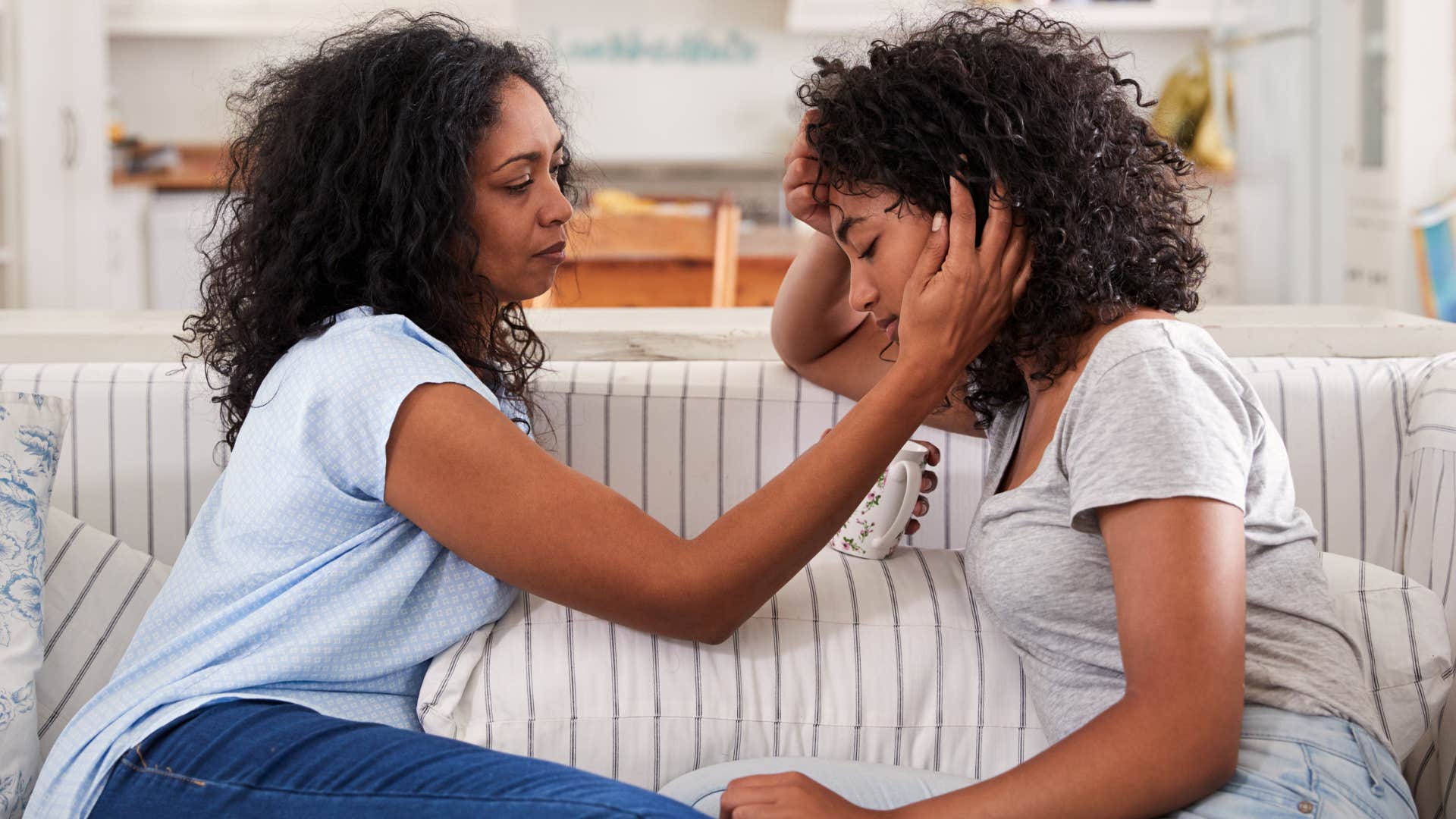 Mother comforting her upset teenage daughter.