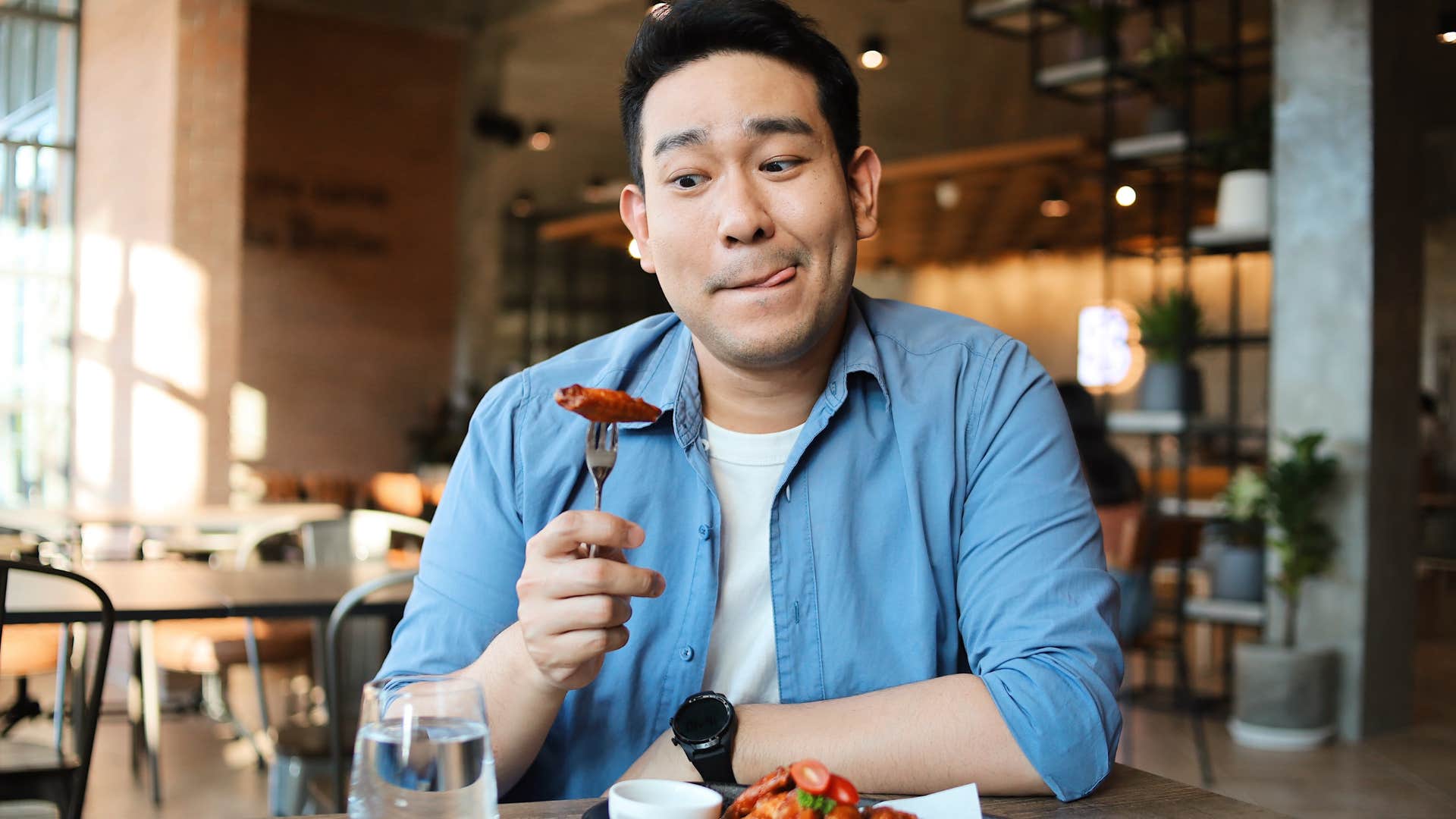 Hungry man admiring food on a fork