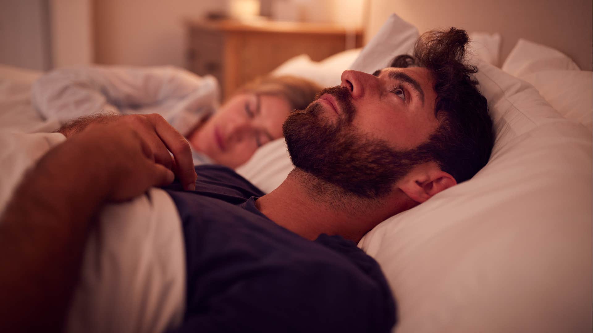 Anxious man lying awake in bed