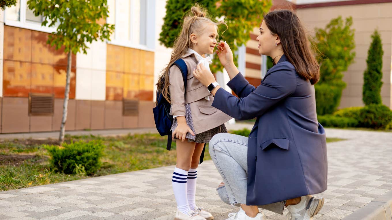 mom accompanies her first-grader daughter to school,