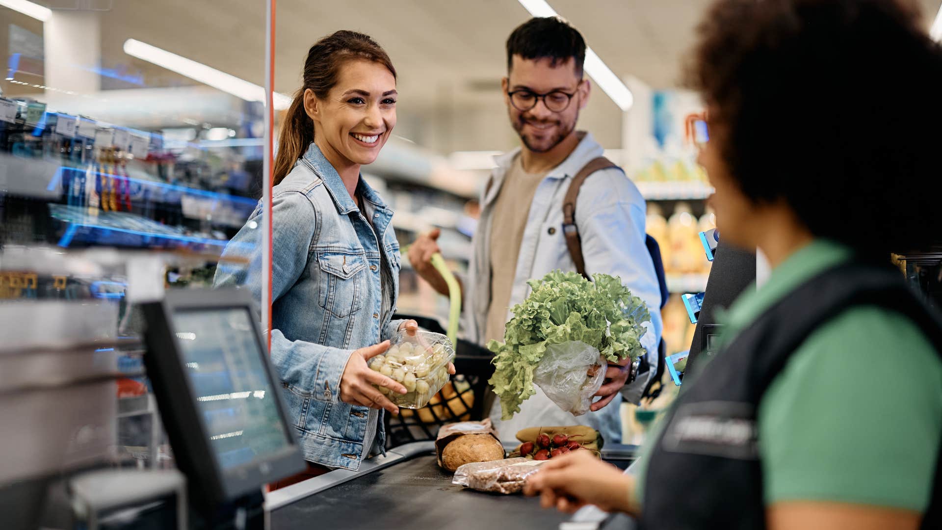 Couple smiling while checking out at the grocery store