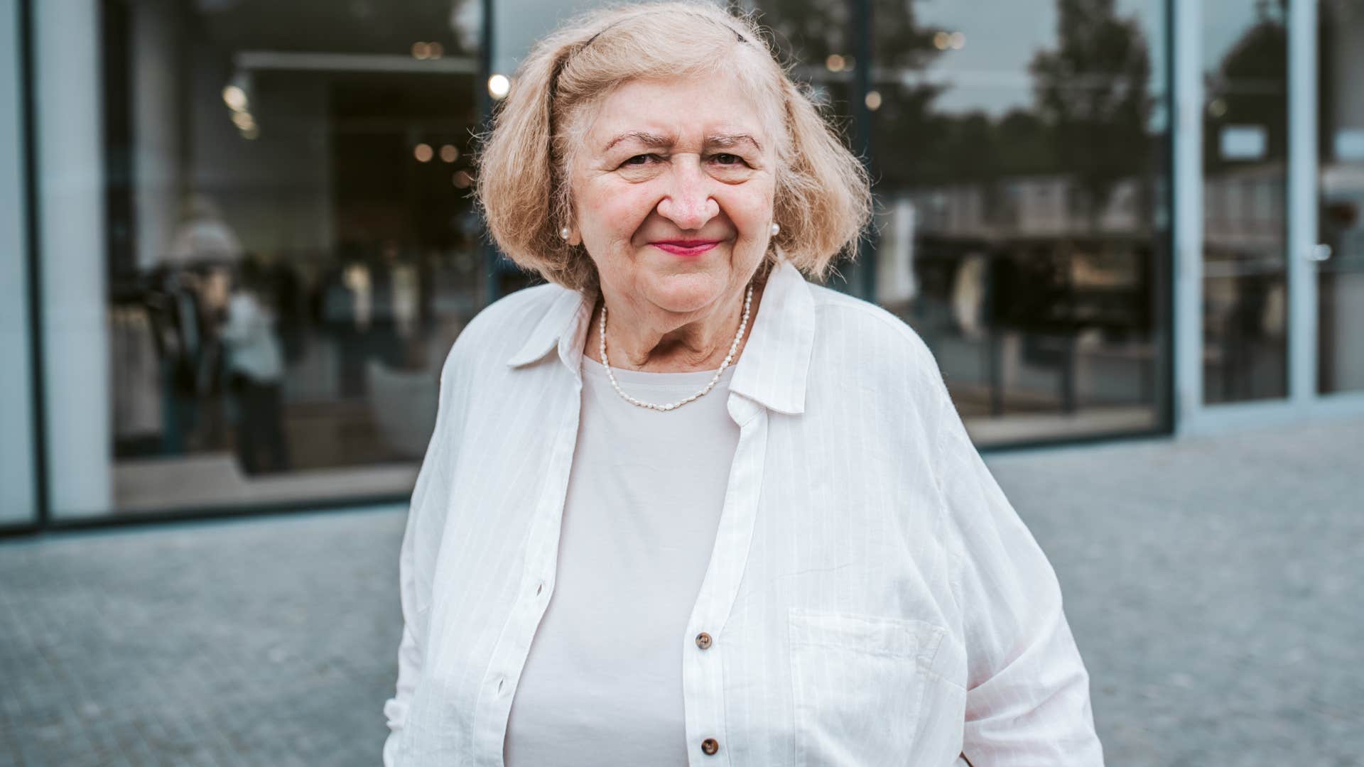 Older woman smiling standing in public